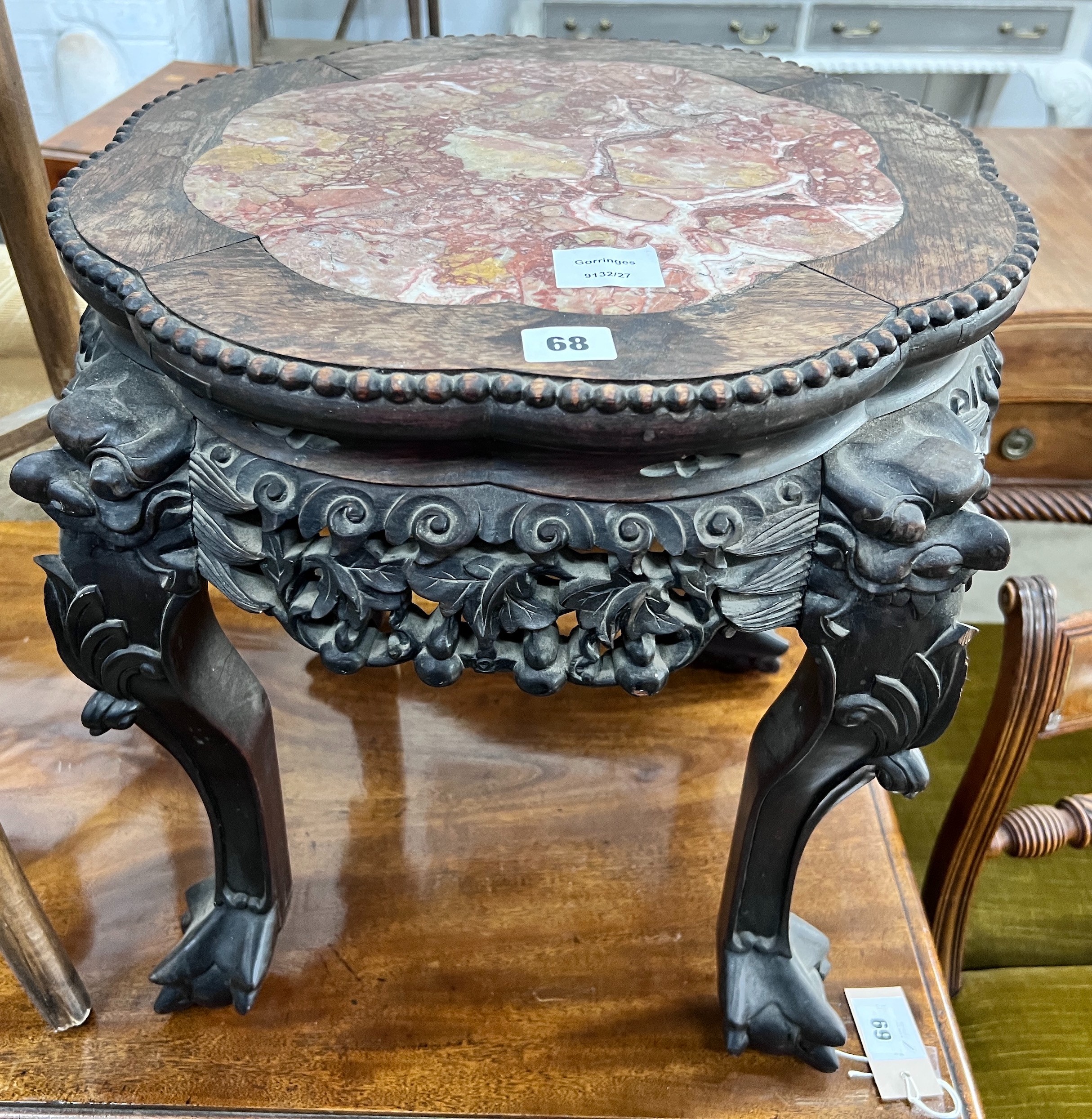 A Chinese carved hardwood rouge marble-topped jardiniere stand, diameter 43cm, height 46cm *Please note the sale commences at 9am.